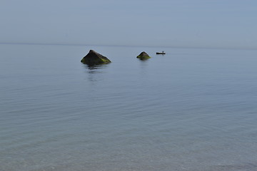 Image showing Fisherman between rocks