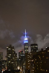 Image showing Empire state building between clouds