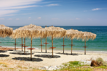 Image showing Reed umbrellas on the beach