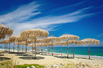 Image showing Reed umbrellas on the beach