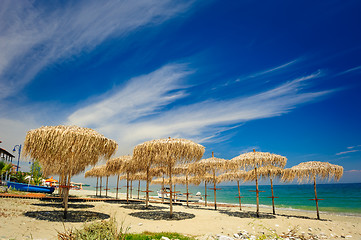 Image showing Reed umbrellas on the beach