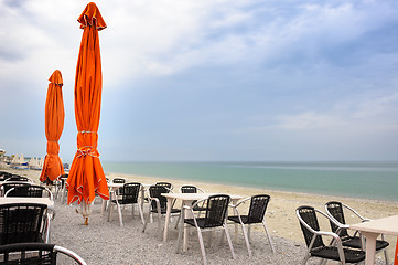 Image showing Beach cafe with empty tables and chairs 