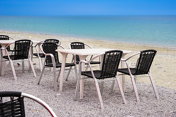 Image showing Beach cafe with empty tables and chairs 