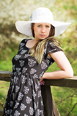 Image showing Cheerful fashionable woman in stylish hat and frock posing