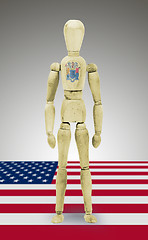 Image showing Wood figure mannequin with US state flag bodypaint - New Jersey