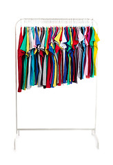 Image showing Multicolored clothes on hangers, isolate