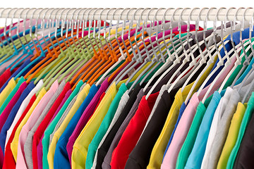 Image showing Colored shirts on hangers steel closeup.