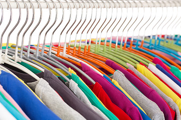 Image showing Collection of colored shirts on steel hangers