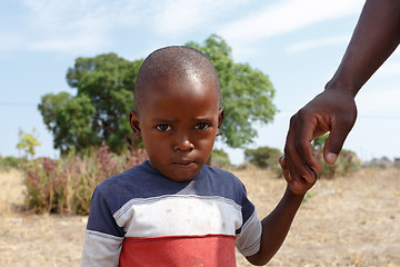 Image showing Portrait of Namibian small boy with fathers hand