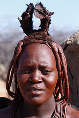 Image showing Himba woman with ornaments on the neck in the village