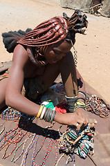 Image showing Himba girl with souvenirs for sale in traditional village