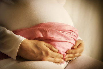 Image showing Pregnant woman is holding her baby bump