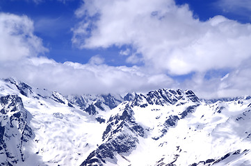 Image showing Snowy mountains in sun day