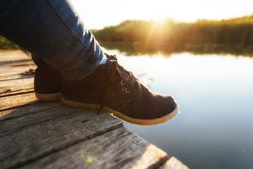 Image showing Woman relaxing on jetty