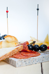 Image showing mix cold cut on a stone with fresh pears