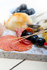 Image showing mix cold cut on a stone with fresh pears