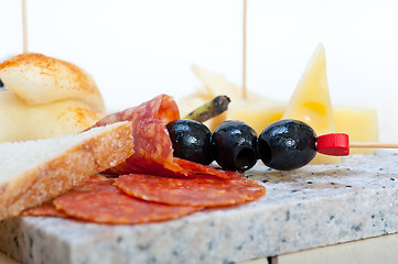 Image showing mix cold cut on a stone with fresh pears