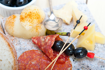 Image showing mix cold cut on a stone with fresh pears