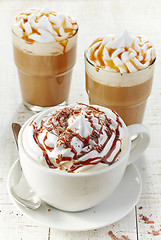 Image showing various coffee cups with whipped cream