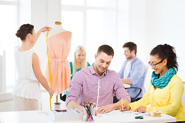 Image showing smiling fashion designers working in office