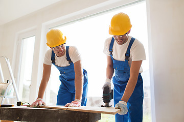 Image showing group of builders with tools indoors