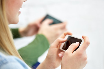 Image showing close up of female hands with smartphone