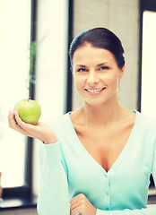 Image showing lovely housewife with green apple