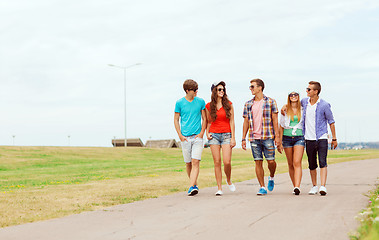 Image showing group of smiling teenagers walking outdoors