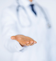 Image showing male doctor holding something in his hand