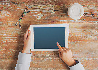 Image showing close up of hands with tablet pc and coffee