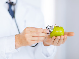 Image showing male doctor with green apple and stethoscope