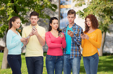 Image showing group of serious teenagers with smartphones