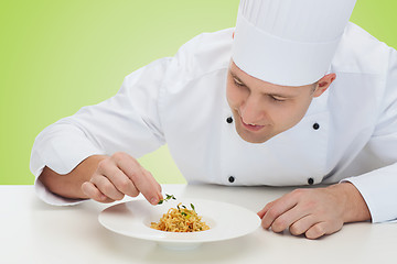 Image showing happy male chef cook decorating dish