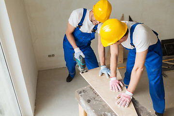 Image showing group of builders with tools indoors