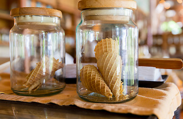 Image showing close up of jars with waffle cones at restaurant