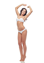 Image showing happy young woman in white bikini swimsuit