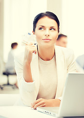 Image showing pensive businesswoman with cash money