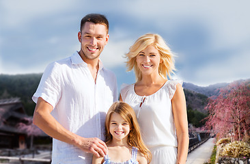 Image showing happy family over hills background