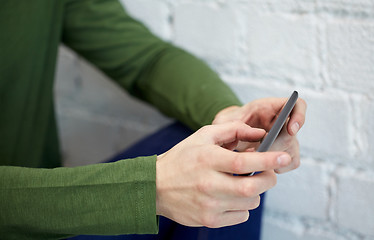 Image showing close up of male hands with smartphone