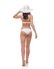 Image showing young woman in white bikini swimsuit from back