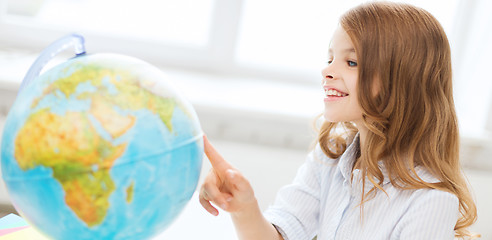 Image showing smiling student girl with globe at school