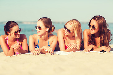 Image showing group of smiling women in sunglasses on beach