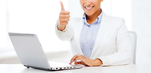 Image showing businesswoman with laptop showing thumbs up