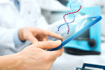 Image showing close up of scientists hands with tablet pc in lab