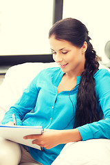 Image showing happy woman with big notepad