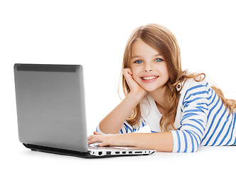 Image showing smiling student girl with laptop computer lying