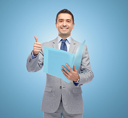 Image showing happy businessman with folder showing thumbs up