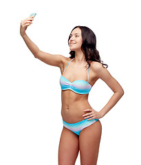 Image showing woman in swimsuit taking selfie with smatphone