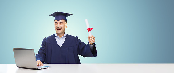 Image showing smiling adult student in mortarboard with diploma