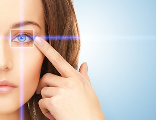 Image showing beautiful woman pointing to eye